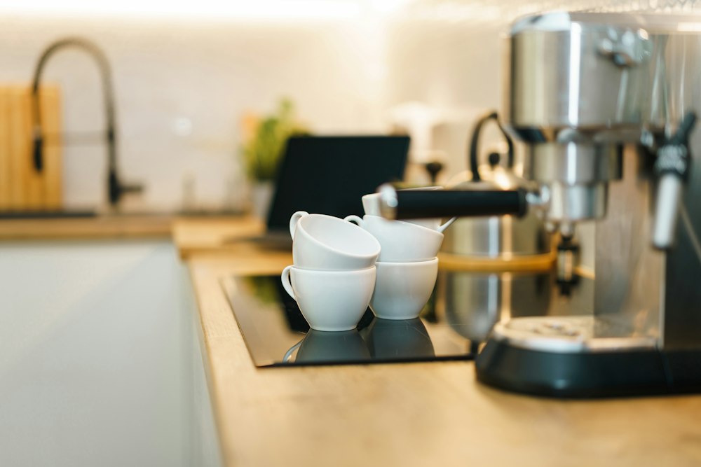Simple countertop coffee station with a machine and cups